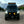 Custom Mercedes Sprinter van displays upgraded off-road features, including a roof rack, LED light bar, and a rugged front bumper. 
